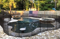Pool with mesh safety fence removable
